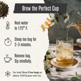 Numi green tea bags steeping in hot water releasing floral notes.
