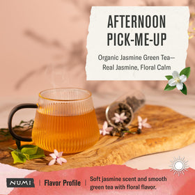 Numi green tea cup steaming with jasmine bloom, inviting a relaxing afternoon.