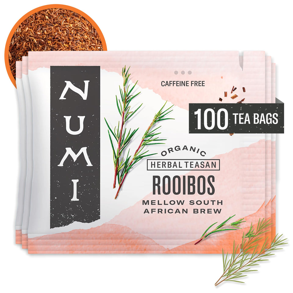 Numi Rooibos tea bags beside a warm amber cup for a caffeine-free sip