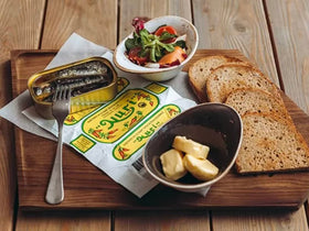 Nuri sardines in serving bowl showcase vibrant sauce and texture.