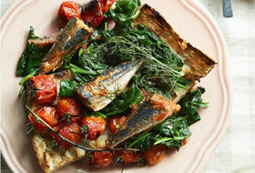 Close-up of Nuri sardines can label, showcasing quality ingredients and tomato sauce.