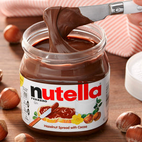 Nutella jar on toast as a breakfast idea with creamy topping.