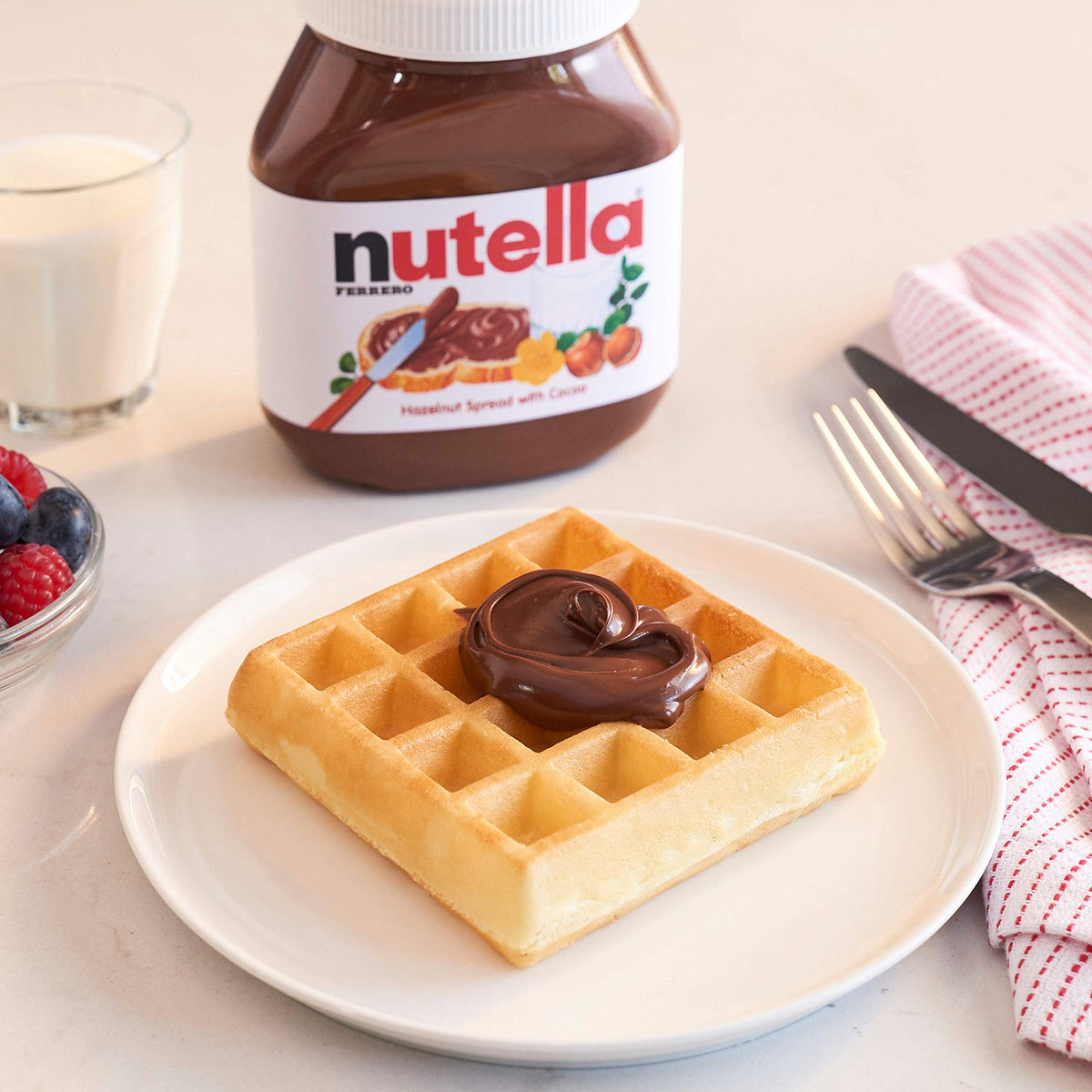 Nutella with pancakes and waffles as a delightful morning topping.