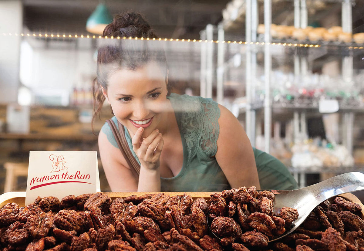 Nuts on the Run Cinnamon Pecans close-up showing glossy pecans and all-natural ingredients.