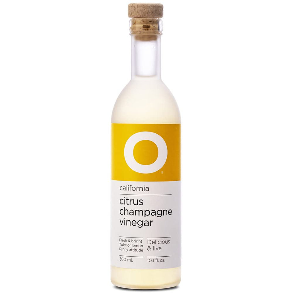 O Olive Oil Citrus Champagne Vinegar bottle pouring enhances bright citrus flavor for salads.