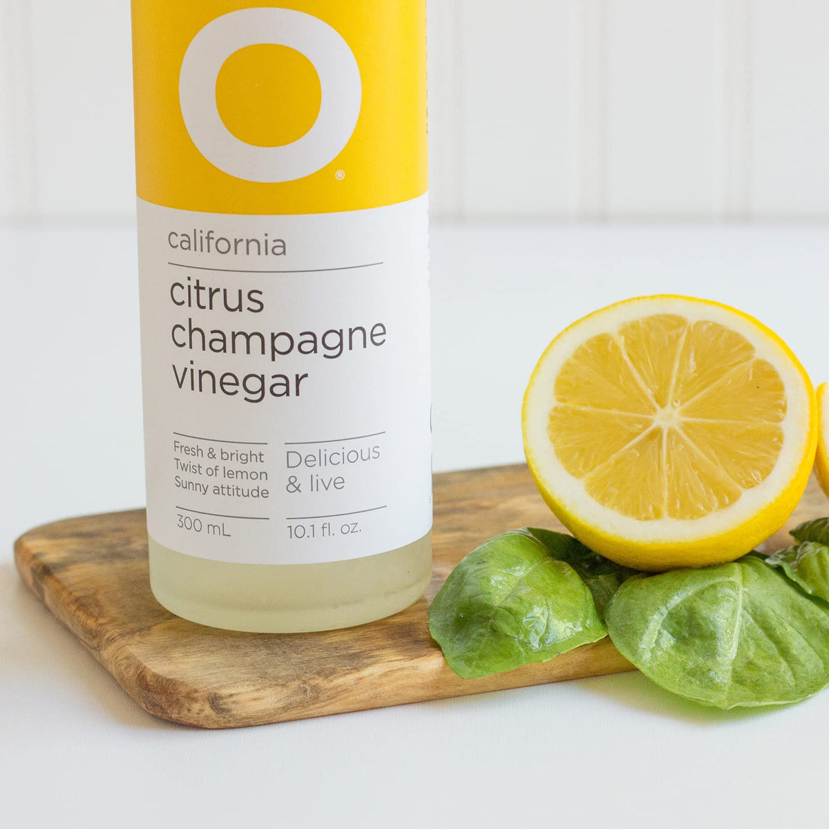 O Olive Oil Citrus Champagne Vinegar label closeup shows vibrant palette for dressings.
