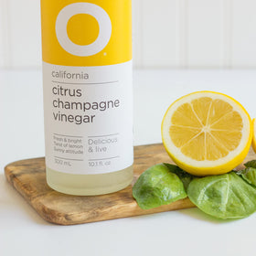 O Olive Oil Citrus Champagne Vinegar label closeup shows vibrant palette for dressings.