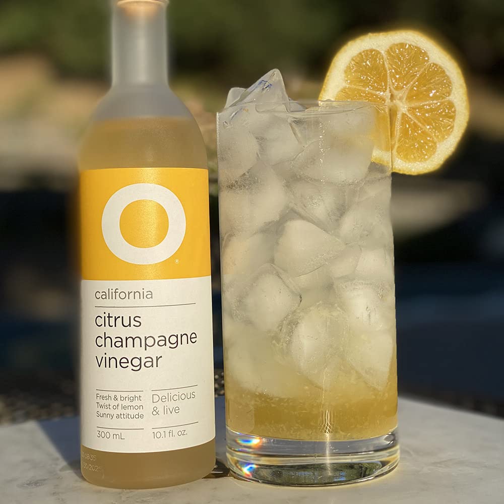 O Olive Oil Citrus Champagne Vinegar salad dressing closeup emphasizes zesty, refreshing profile.