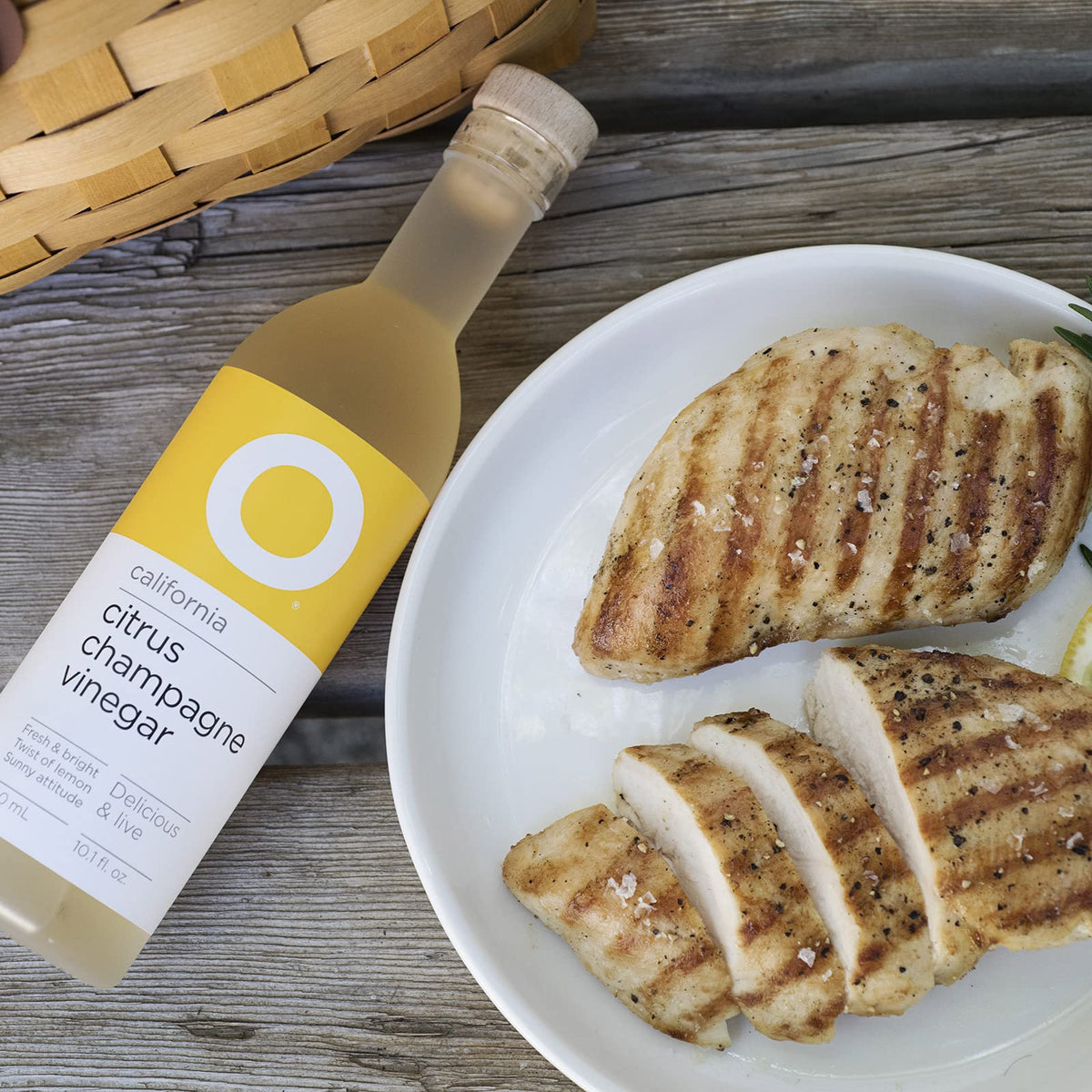 O Olive Oil Citrus Champagne Vinegar sparkles in a glass, elevating sparkling water.