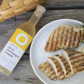 O Olive Oil Citrus Champagne Vinegar sparkles in a glass, elevating sparkling water.