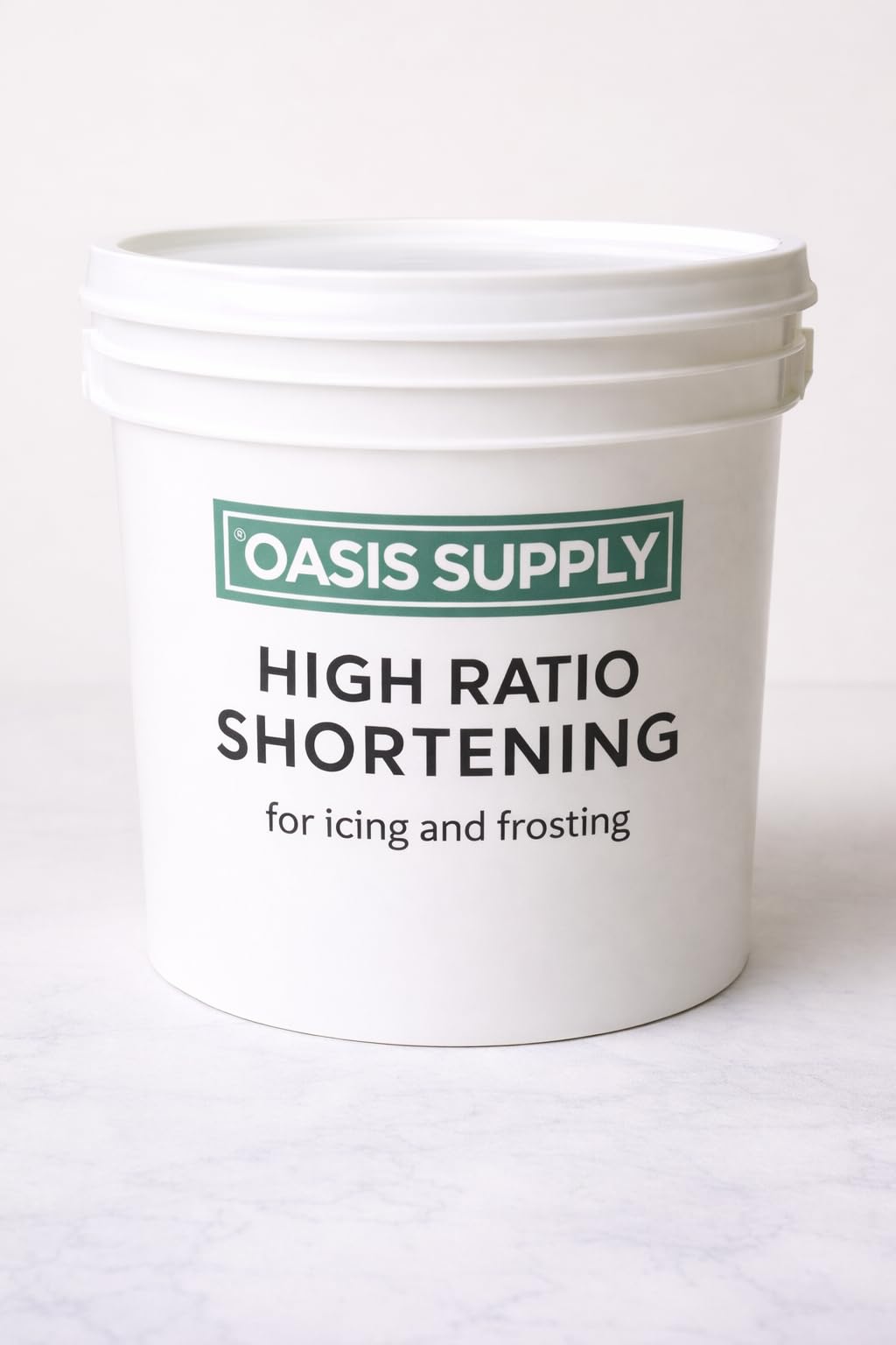Oasis Supply high ratio flex icing shortening bottle with glossy icing and zero trans fat.