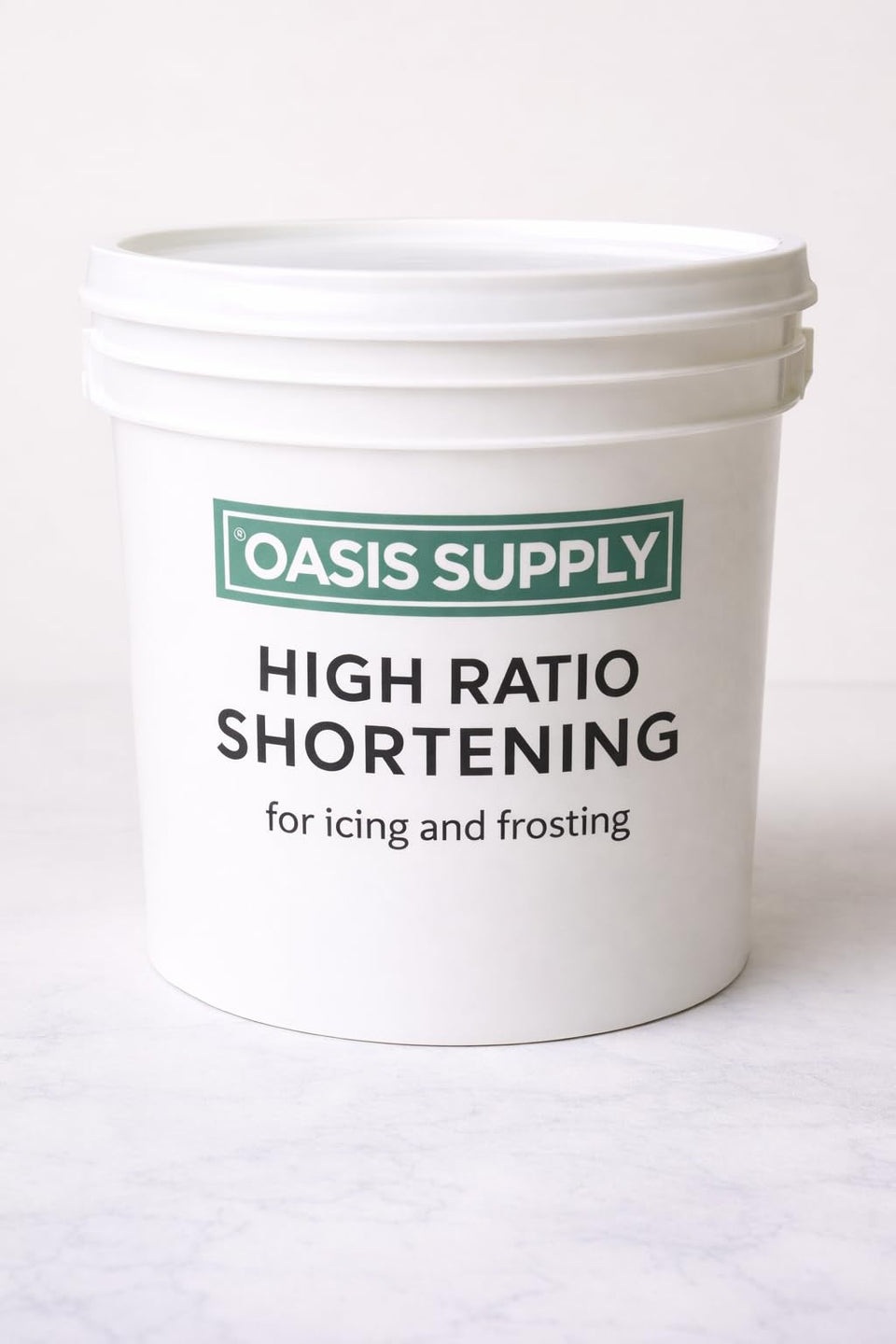 Oasis Supply high ratio flex icing shortening bottle with glossy icing and zero trans fat.