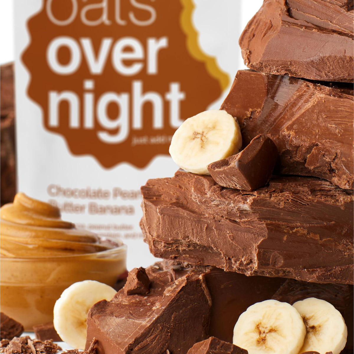 Pour action shot of Oats Overnight Chocolate Peanut Butter Banana shake.