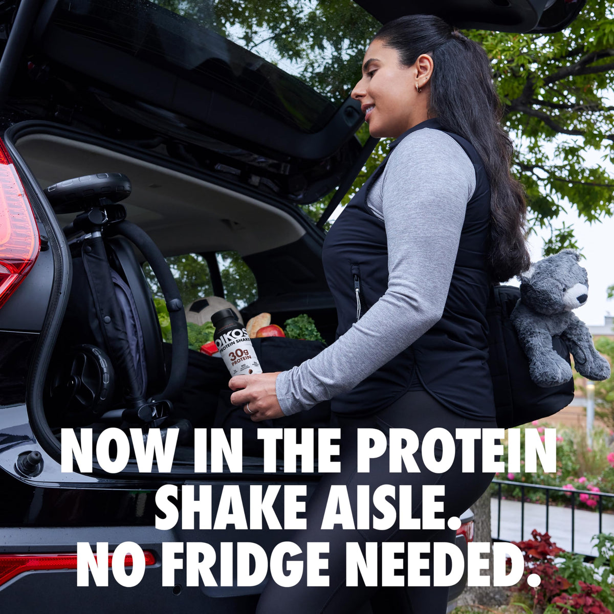 Oikos Chocolate Protein Shake with straw beside a gym bag