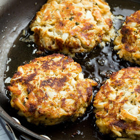 Preparing Old Bay Crab Cake Classic Mix with crab meat in a bowl