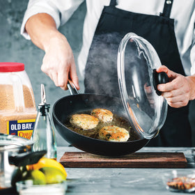 Crispy Old Bay crab cakes plated with lemon.