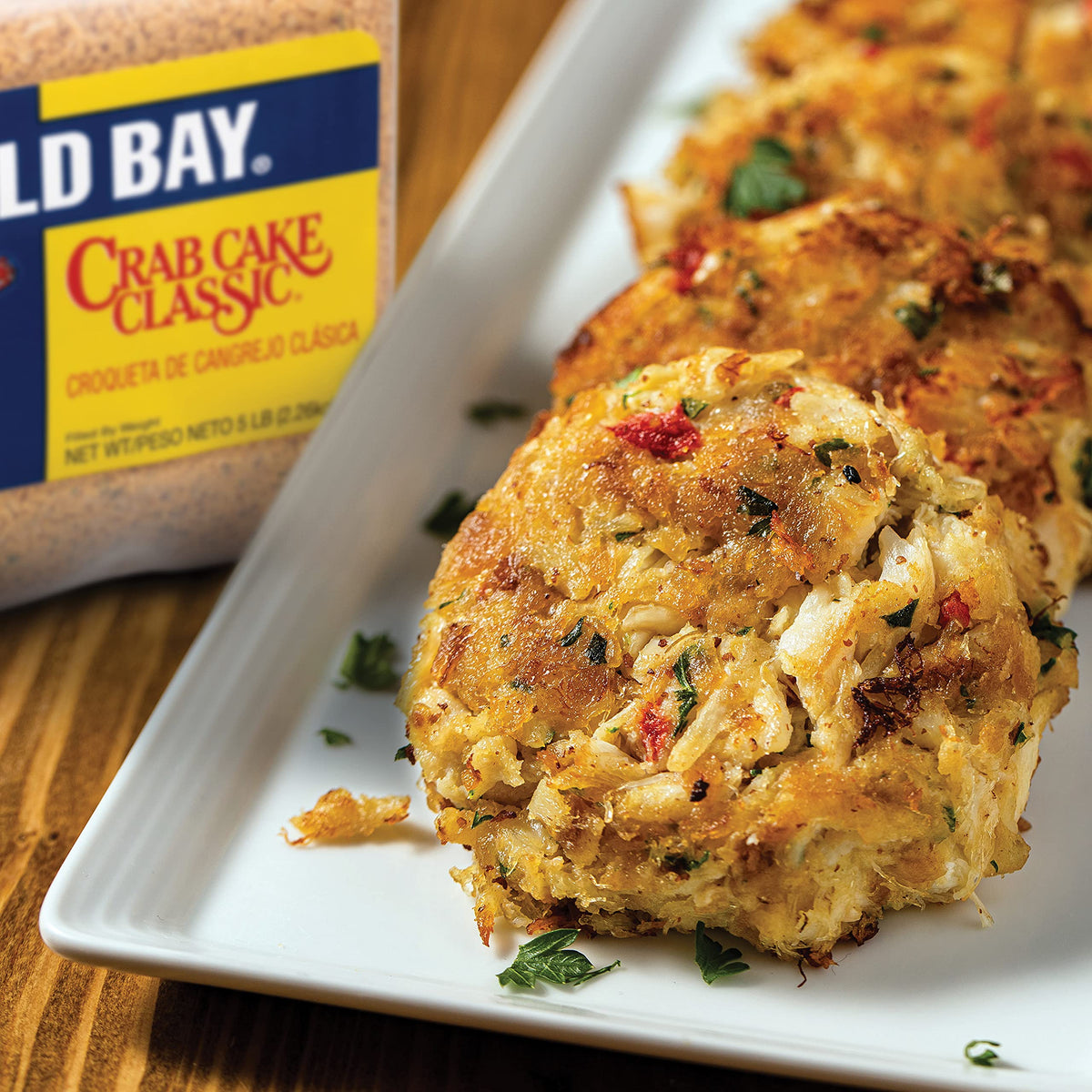 Old Bay seasoning poured to start a coastal-inspired dish.