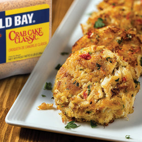 Old Bay seasoning poured to start a coastal-inspired dish.