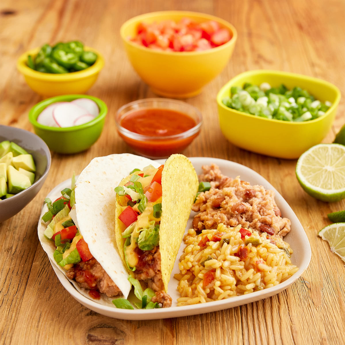 Old El Paso Cheesy Mexican Rice Mix at a taco bar setup, crowd-pleasing base.