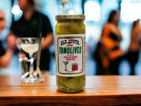 Old South Tomolives jar-closeup highlighting tangy pickled green tomatoes