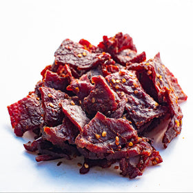 Close-up of Old Trapper jerky strips reveals tender texture and smoky finish