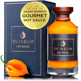 Oliveum hot sauce bottle top with walnut cap and copper medallion.