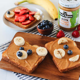 Once Again Peanut Butter Smooth spoon dip shows creamy texture for snacking.