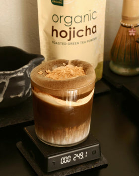 One Organic Hojicha powder cup steams with warm aroma.