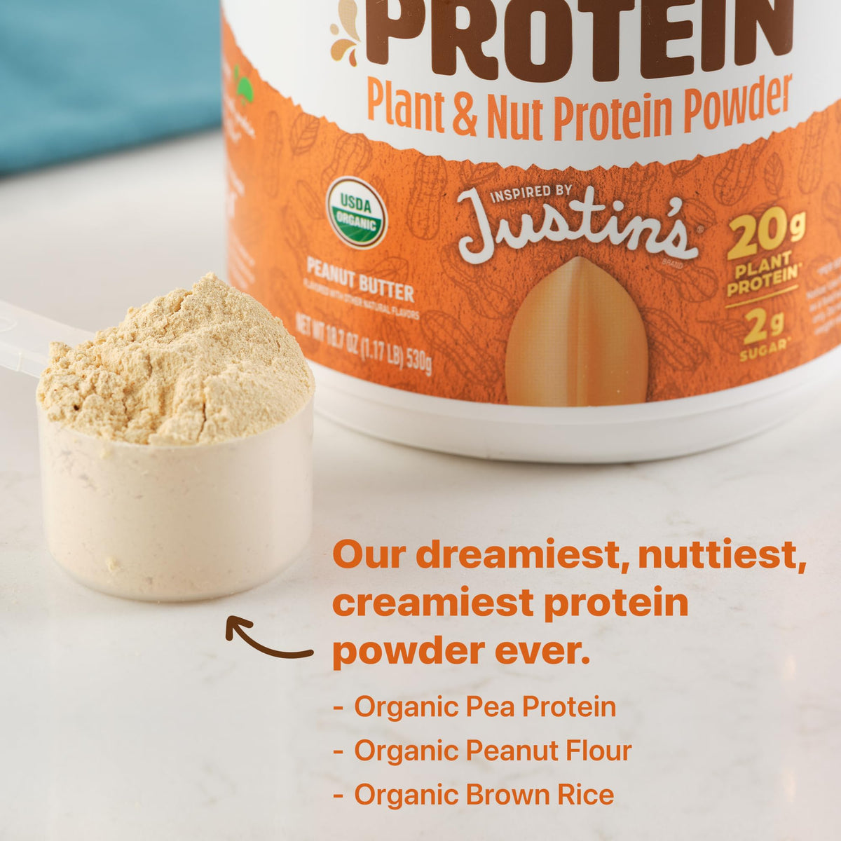 Banana smoothie with Orgain x Justin’s Nut Butter Protein Powder visible.