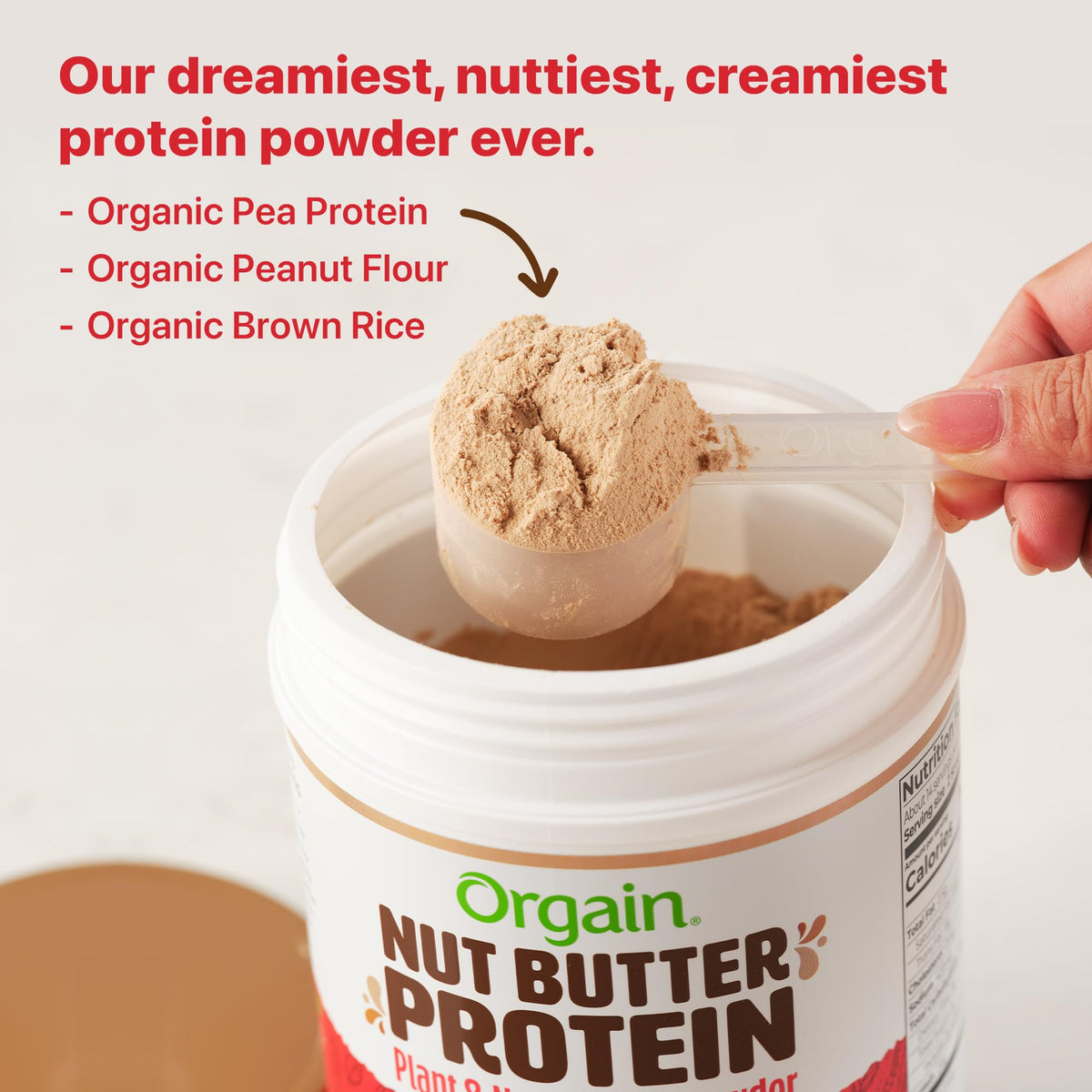 Orgain X Justin's Nut Butter Protein Powder being poured into a shake.