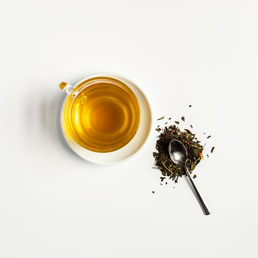 Organic Positively Green Tangerine steeped tea in a mug evokes citrusy comfort during breaks.