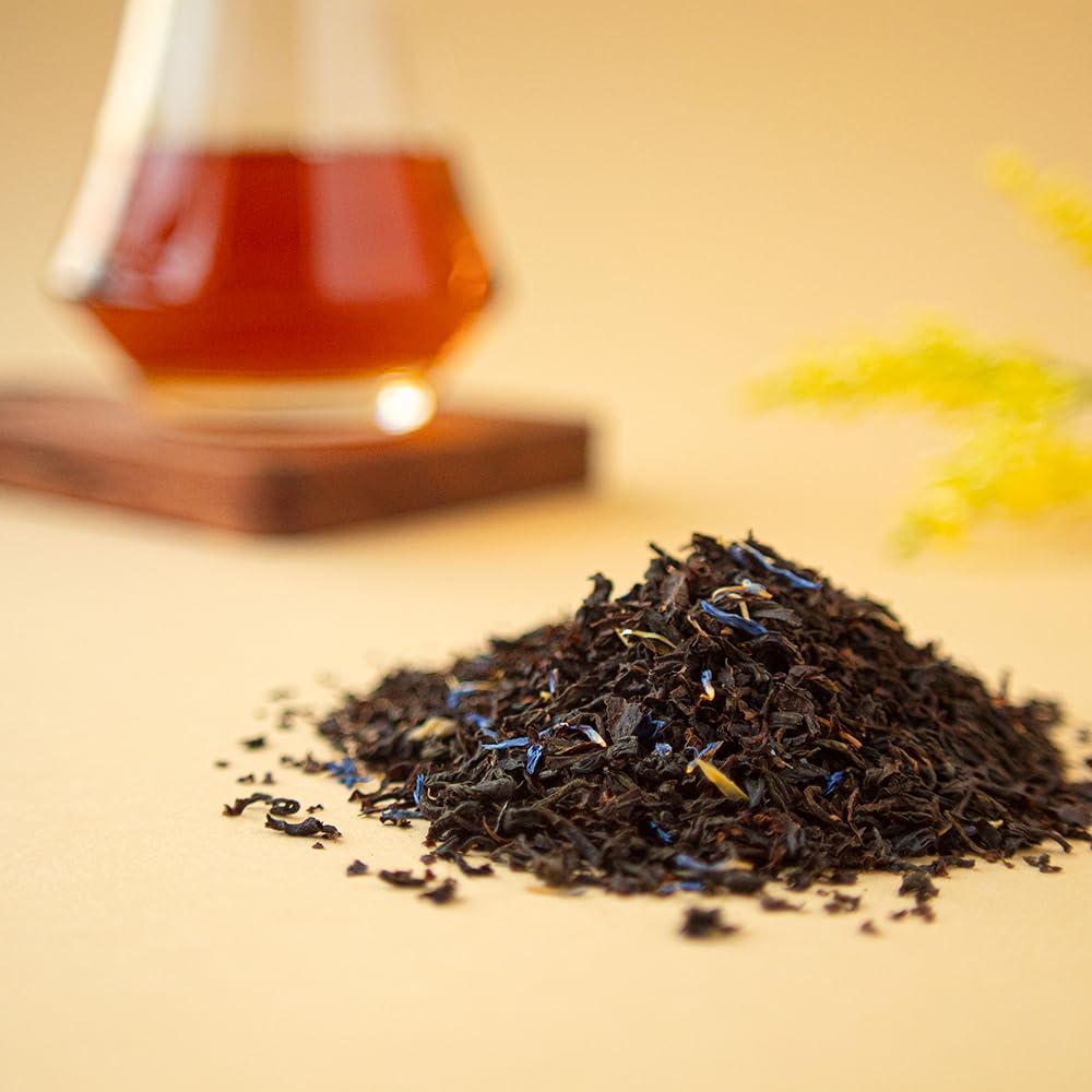Organic Positively Tea Co cup of Earl Grey Creme glowing under soft light.