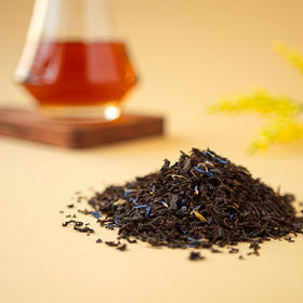 Organic Positively Tea Co cup of Earl Grey Creme glowing under soft light.