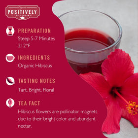 Organic Positively Tea Company hibiscus tea cup shows vibrant red liquor for refreshing beverages.