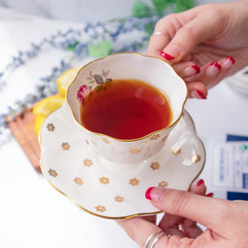 Organic Positively Tea Company red-gold tea color swirling in cup.