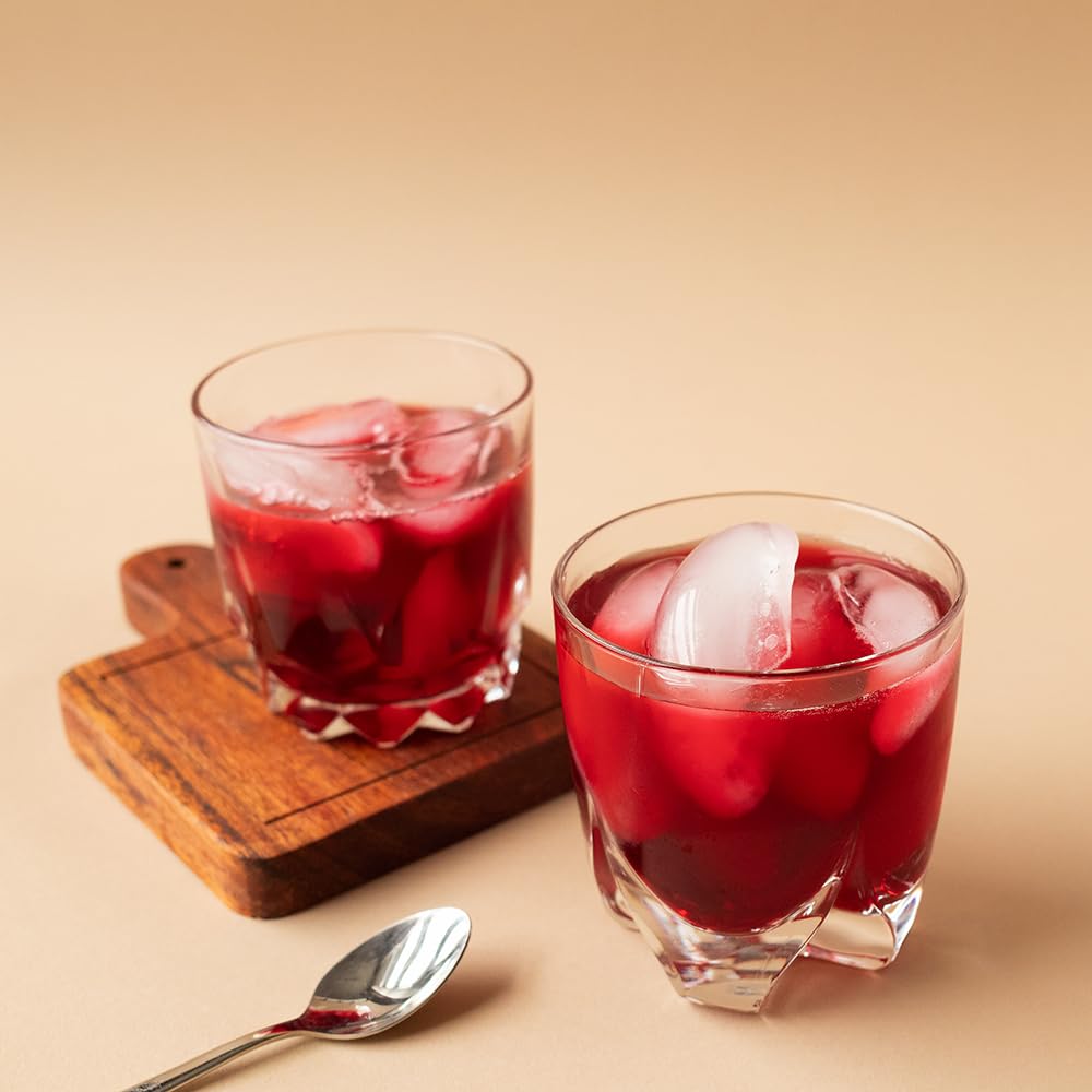 Organic Positively Tea Company's Very Berry Citrus infusion in a clear cup shows vibrant color and berry notes.