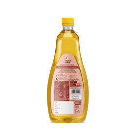 Organic Tattva groundnut oil pouring into pan, ideal for sautéing.