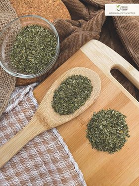 Organic Way Moringa leaves being blended with herbs emphasizes versatile culinary use.