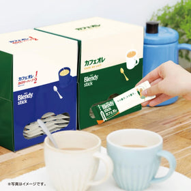 OSK Blendy Stick Café au Lait stick dissolving in hot water for creamy preparation.