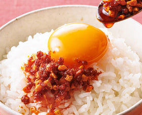Close-up of OSK chili oil with crunchy garlic bits highlighting texture and flavor.