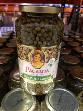 Paesana Organic Non Pariel Capers bottle close-up highlighting tangy brininess for elevating sauces