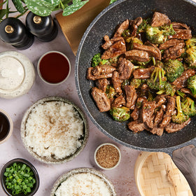 Panda Brand Sauce being poured over broccoli beef for quick dinner.
