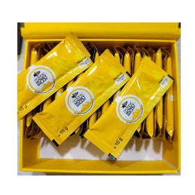 Paramount Honey Shilajit sachets beside a warm mug demonstrate easy mixing into tea.
