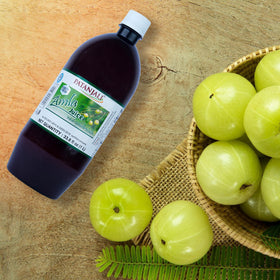 Patanjali Amla Juice label close-up, trusted 1L bottle for kitchen staples.