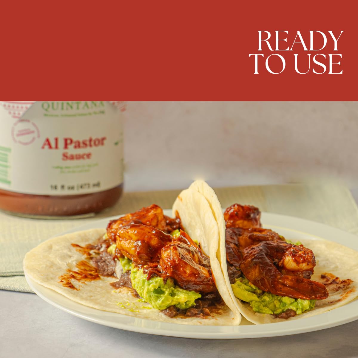 Patricia Quintana Al Pastor tacos ready with sauce drizzle for vibrant seasoning.