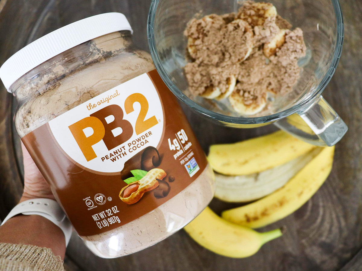PB2 Cocoa powder shake glass suggests creamy flavor with 90% less fat.