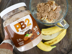 PB2 Cocoa powder shake glass suggests creamy flavor with 90% less fat.