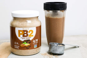 PB2 cocoa powder stirred in mug demonstrates simple chocolate flavor with fewer calories.