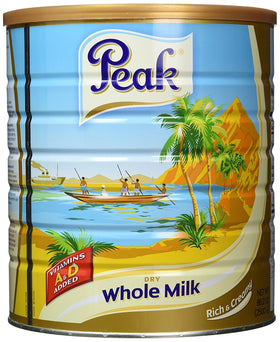 Peak Dry Whole Milk Powder poured into a glass for a creamy, rich drink.