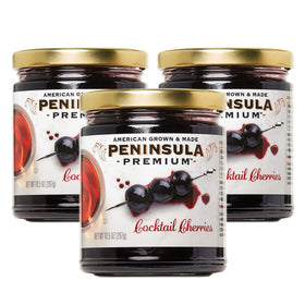 Peninsula Premium Cocktail Cherries bottle with deep burgundy fruit for luxe cocktails.